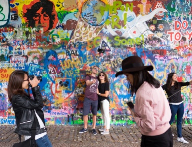 Tourists at the Lennon Wall, Prague (16mm, 1/125s, f2.2, ISO 200)